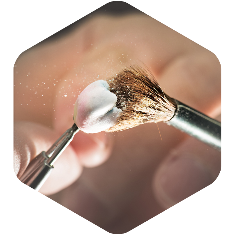 A dental crown being brushed.